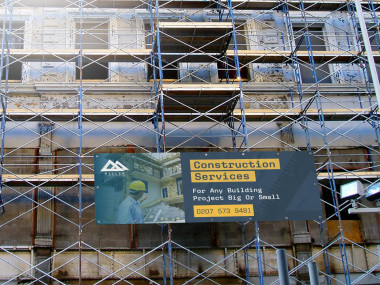 Custom printed construction site banner with company branding
